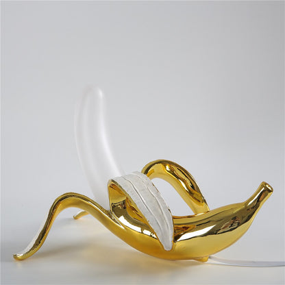 GildedSchälen: Verspielte Tischlampe in Bananenform mit Goldener Oberfläche